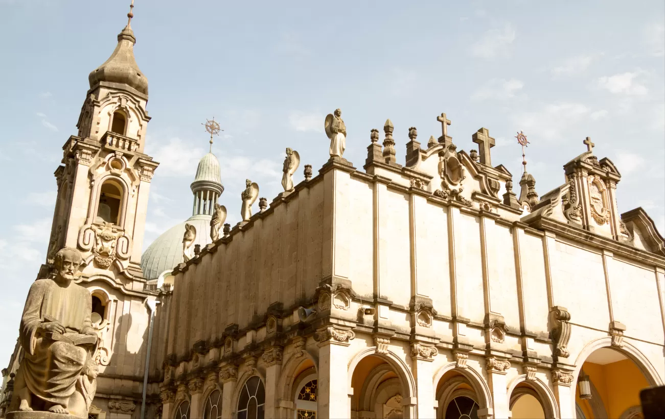 	Holy Trinity Cathedral facade with statues and bell tower in Addis Ababa, Ethiopia