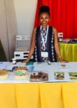 Yama Ethiopia Tours team member at the Ethiopia travel exhibition booth showcasing brochures