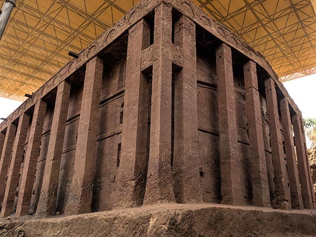Close-up of the carved stone facade and pillars of a rock-hewn church in Lalibela, Ethiopia