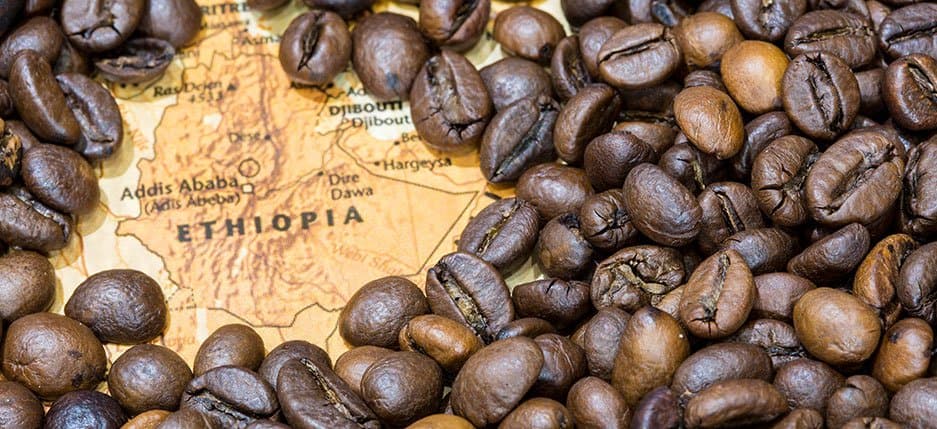 Roasted coffee beans surrounding a vintage map of Ethiopia