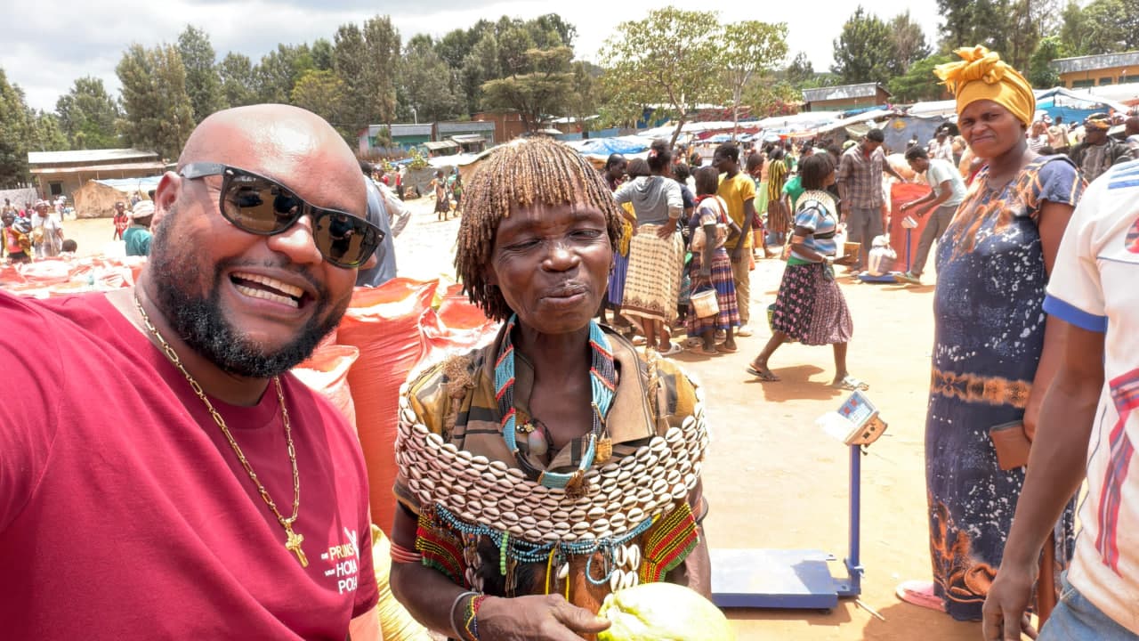 Traveler posing with a Hamar woman at a traditional weekly market in South Omo, Ethiopia