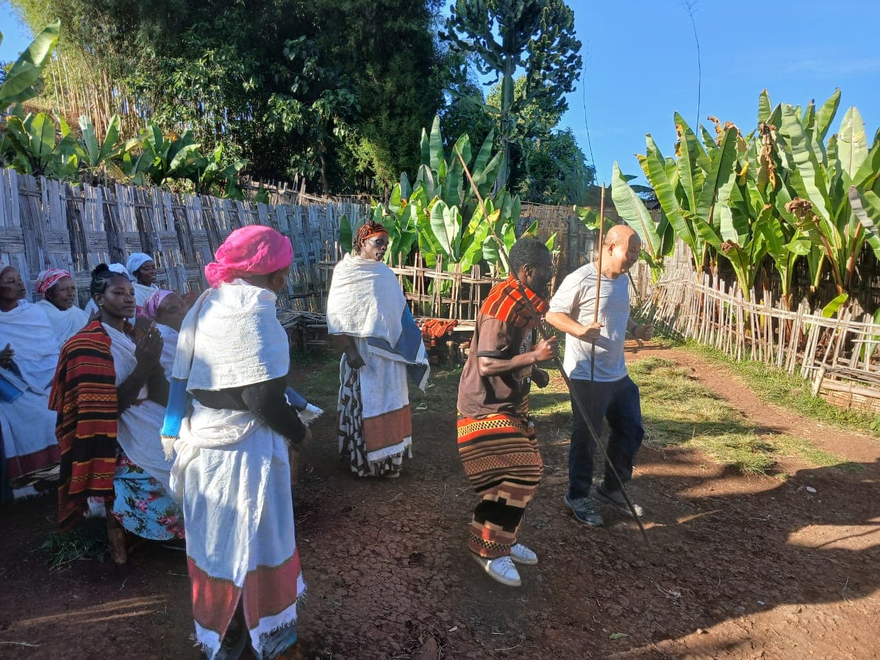 Tourists and villagers taking part in a traditional dance ceremony