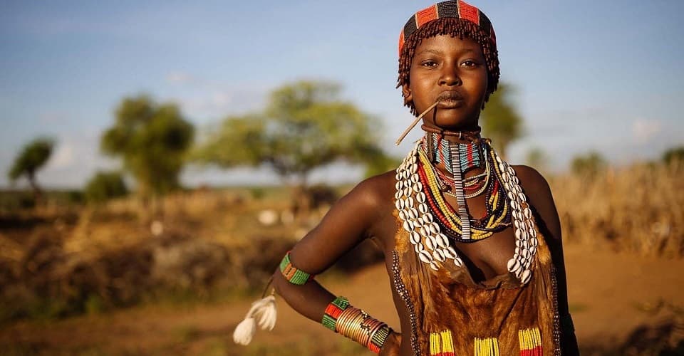 Portrait of a Hamar woman in traditional beaded jewelry and dress, southern Ethiopia