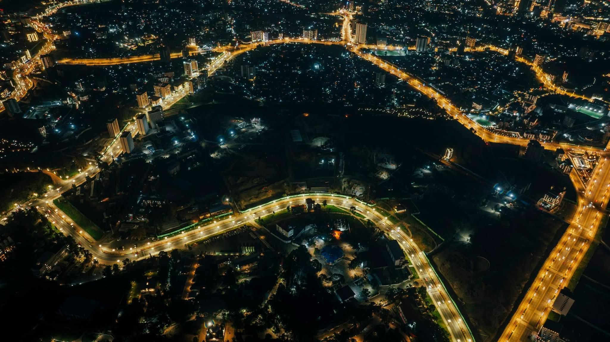 Aerial night view of Addis Ababa showing illuminated corridor roadways and glittering city lights
