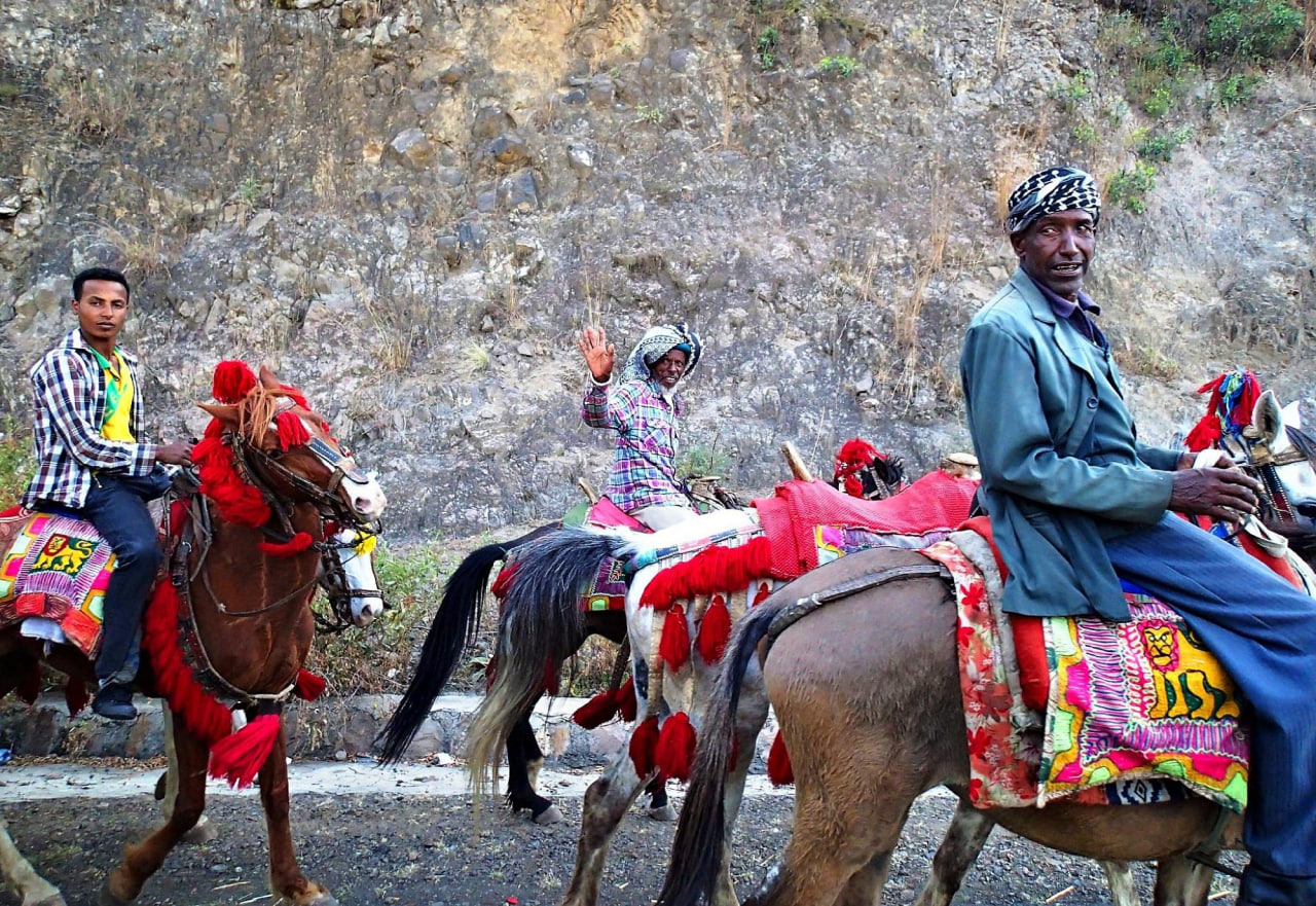 Local riders on brightly decorated horses during a festival in the Ethiopian highlands