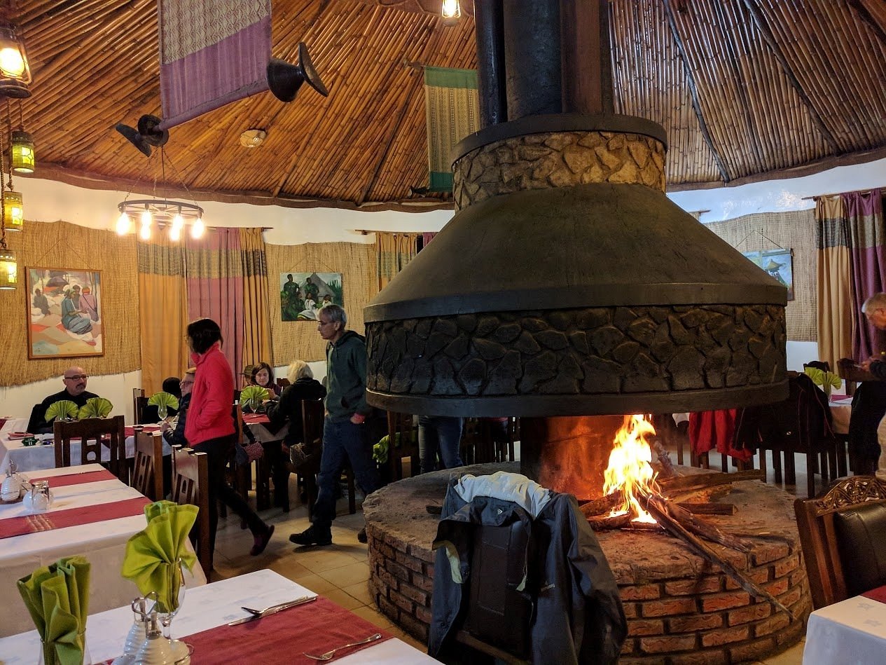 Cozy thatched-roof restaurant with a central open fireplace, Ethiopia