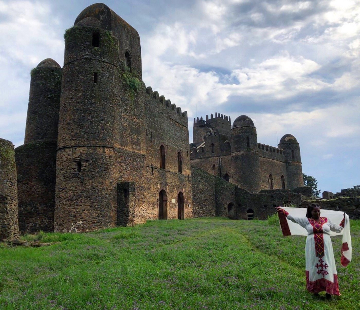 Woman in traditional Ethiopian dress at the Fasil Ghebbi royal enclosure, Gondar