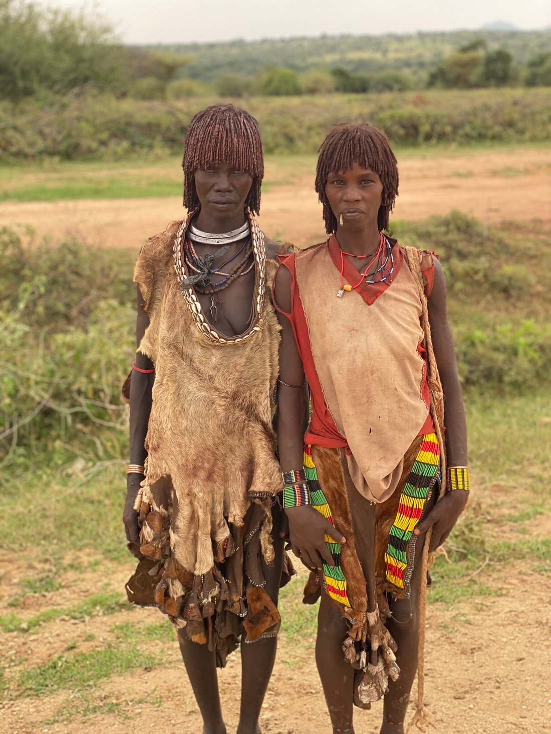Two Hamar women in traditional leather dress and beaded jewelry, Omo Valley