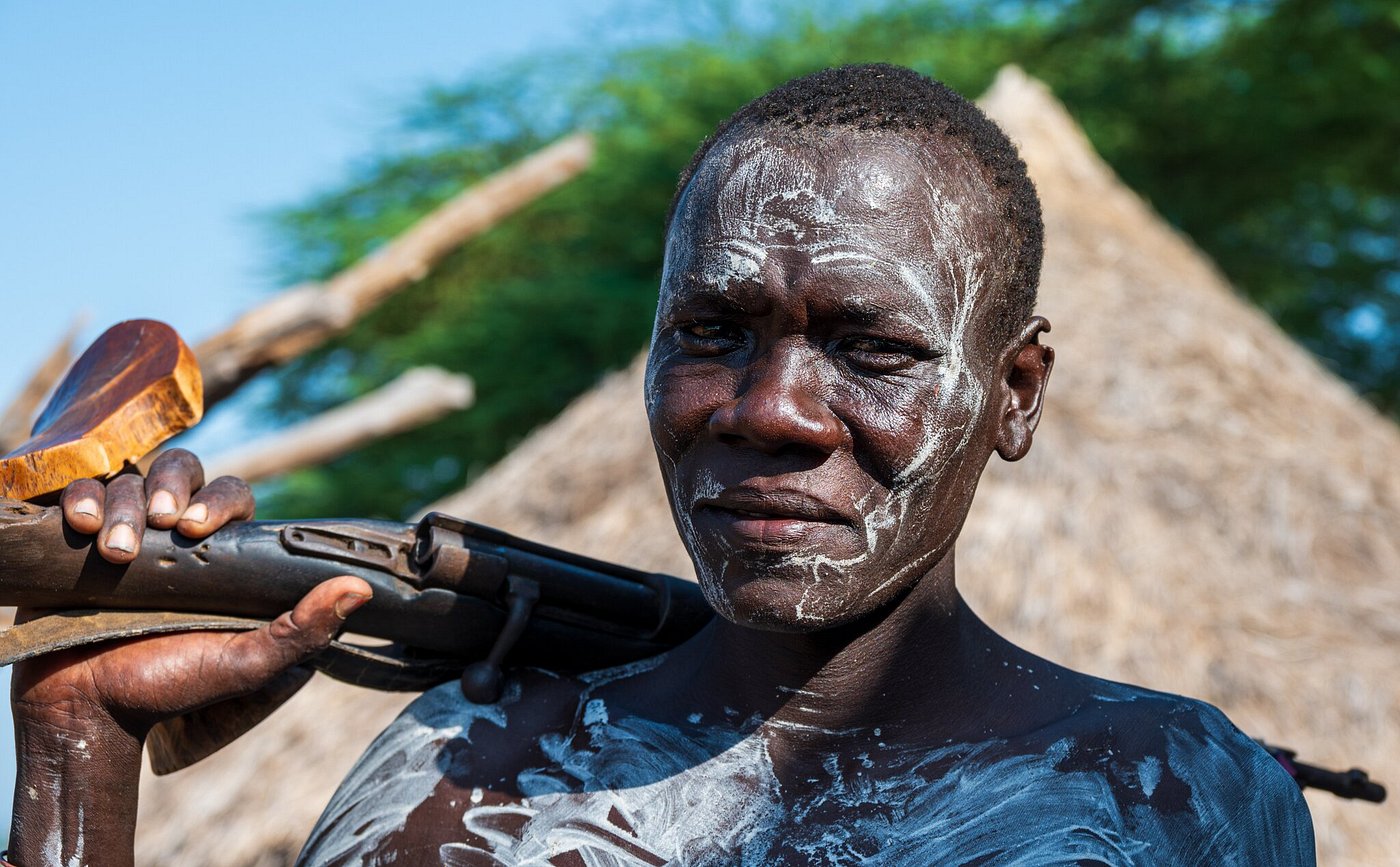 Portrait of a South Omo tribesman with traditional white body paint, Ethiopia