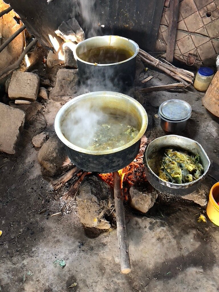 Pots simmering over an open cooking fire in a traditional Ethiopian kitchen