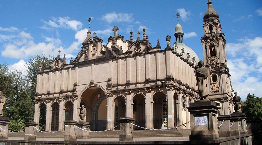 Holy Trinity Cathedral's ornate facade and bell tower against a blue sky in Addis Ababa