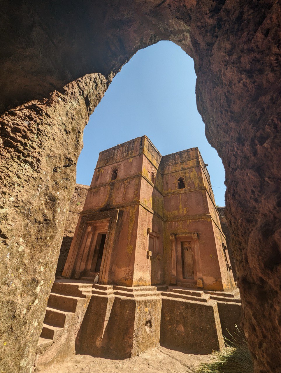 Rock-hewn church in Lalibela viewed through a carved stone archway, Ethiopia